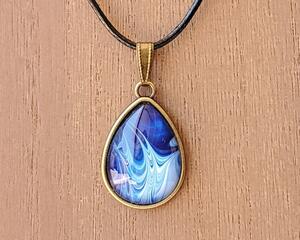 25mm tear drop shape glass set in bronze tone metal alloy painted with pour paint technique. one of a kind.